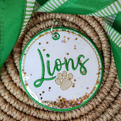 Lions in the hoop bag tag with glitter